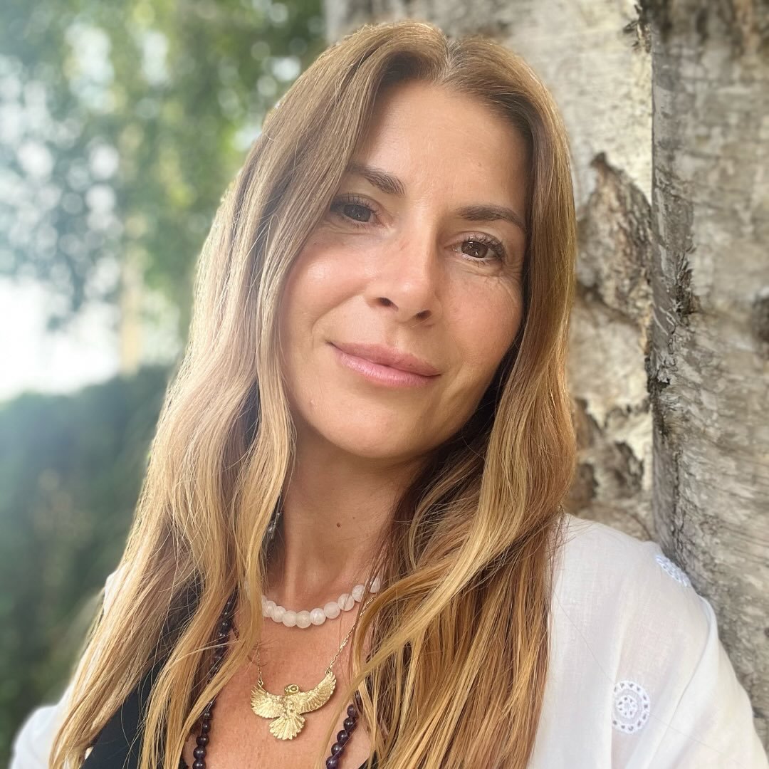Adriana Bogoeva beside a tree in a peaceful green setting
